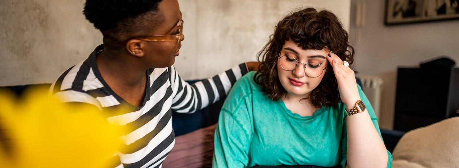 A friend comforting another person aspect ratio 1512 554