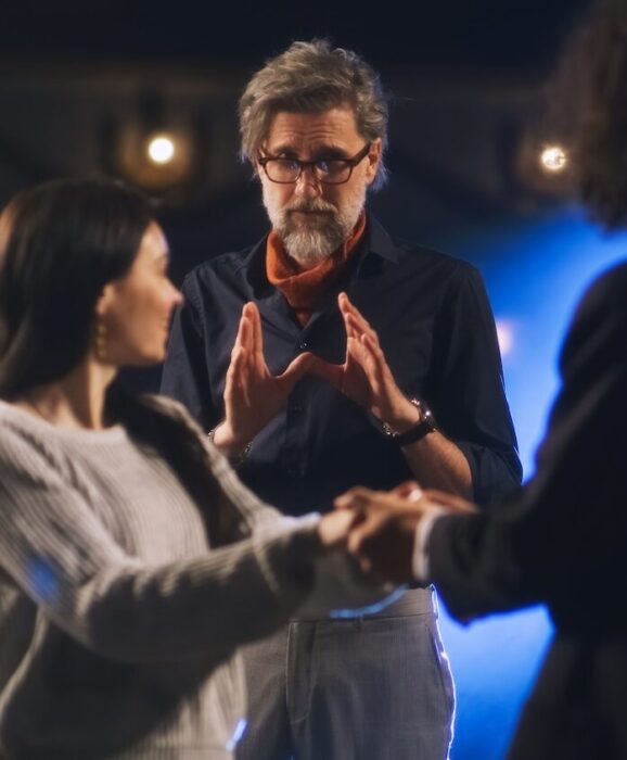 Director directing two actors aspect ratio 303 367 1