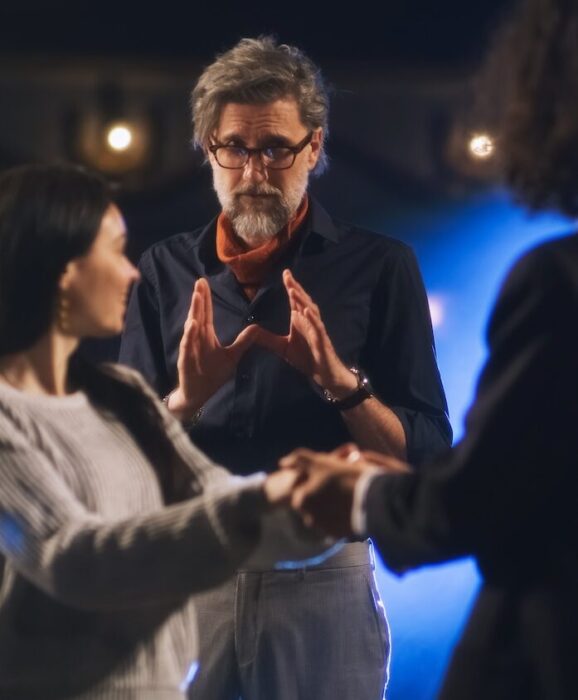 Director directing two actors aspect ratio 303 367 2