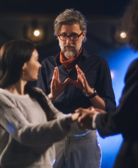 Director directing two actors aspect ratio 303 367 3