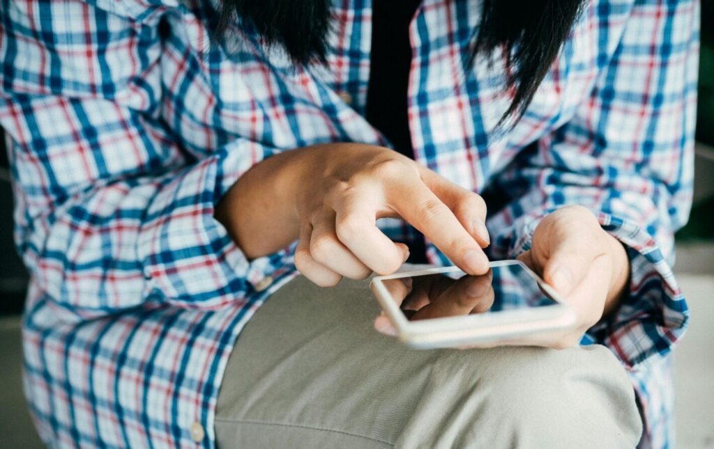 Shout-Imagery-close-up-of-person-on-phone-aspect-ratio-480-302