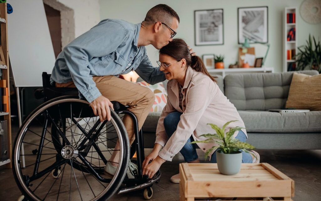 Person-in-Wheelcare-kissing-partner-on-forehead-aspect-ratio-1024-644
