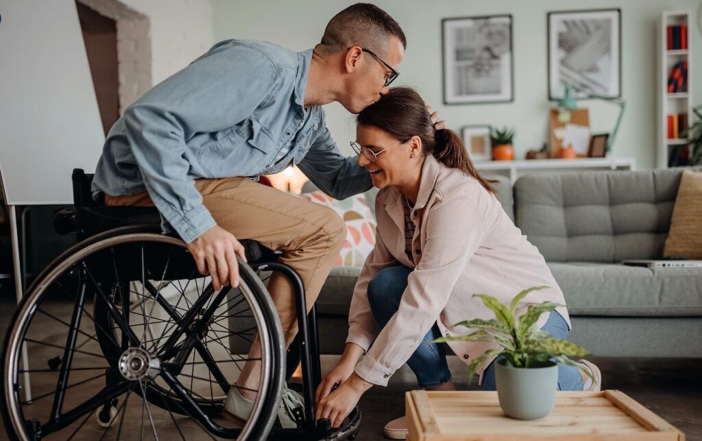Person-in-Wheelcare-kissing-partner-on-forehead-aspect-ratio-1024-644