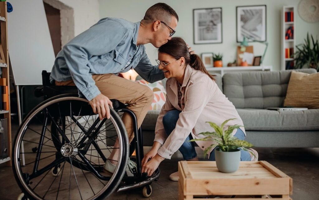 Person-in-Wheelcare-kissing-partner-on-forehead-aspect-ratio-1024-644